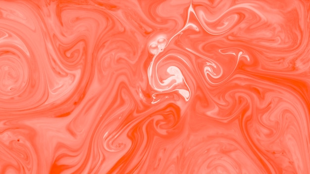 An orange and white mixed paint liquid texture background