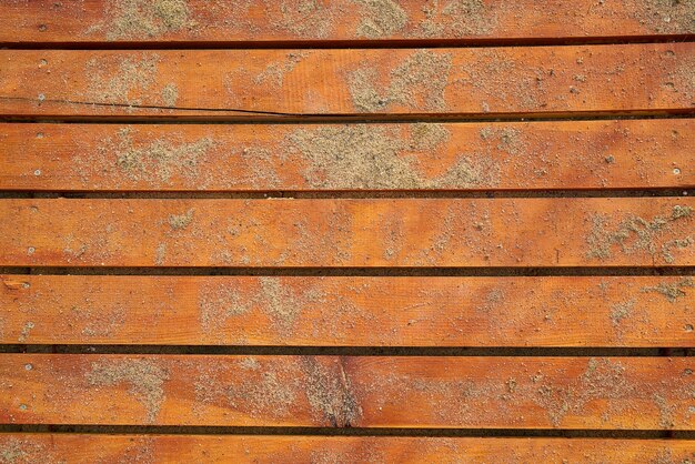 Orange wooden floor with sand