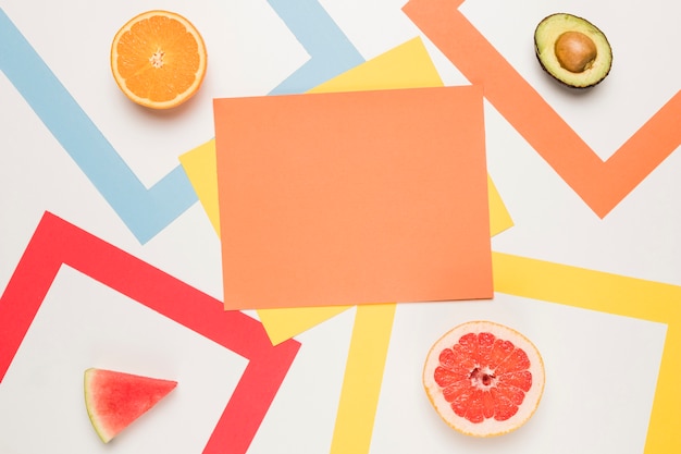 Orange yellow sticky notes and sliced orange avocado grapefruit watermelon 