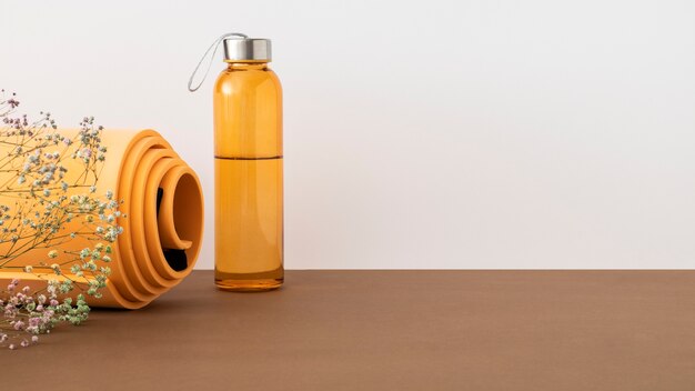 Orange yoga mat and water bottle