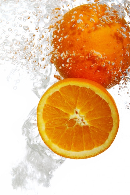 Oranges dropped into water