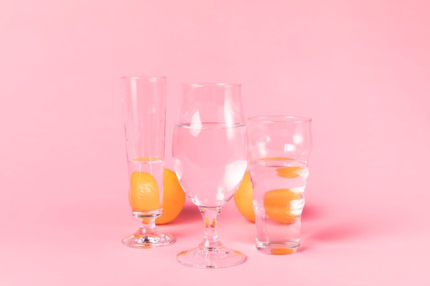 Oranges behind glasses of water