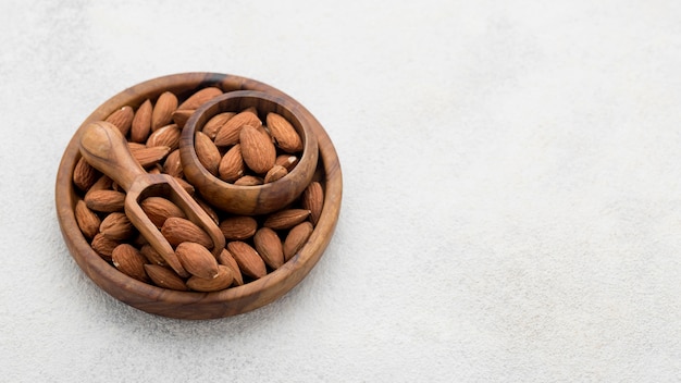 Organic almond nuts in bowl copy space