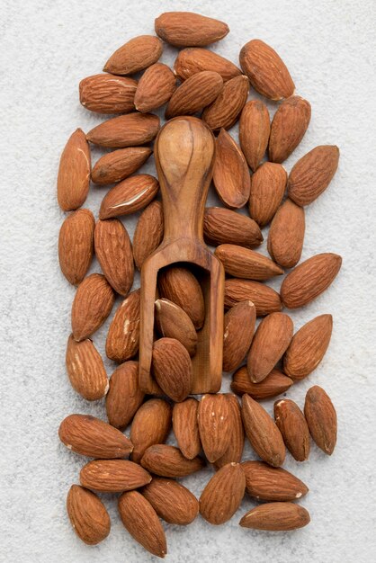 Organic almond nuts and wooden spoon  flat lay