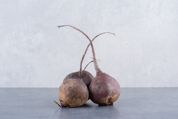 Organic beetroots isolated on concrete surface