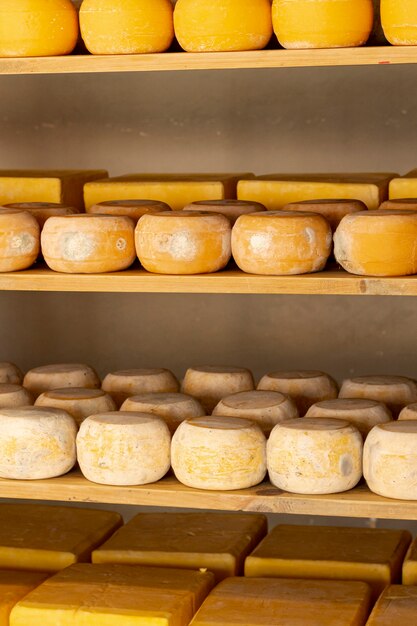 Organic cheese wheels on shelf