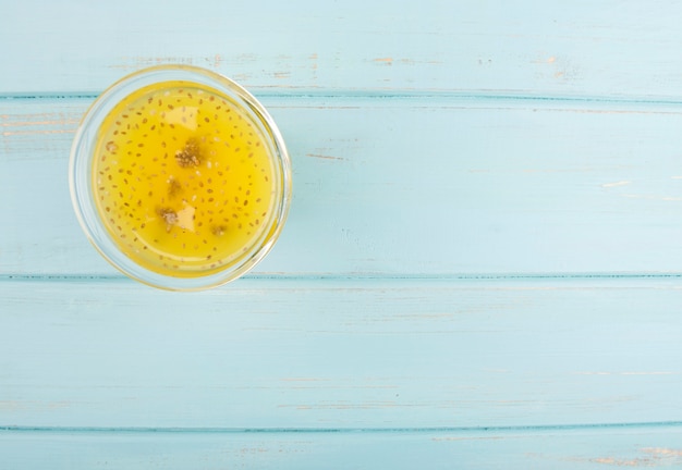 Organic citrus smoothie on blue wooden background