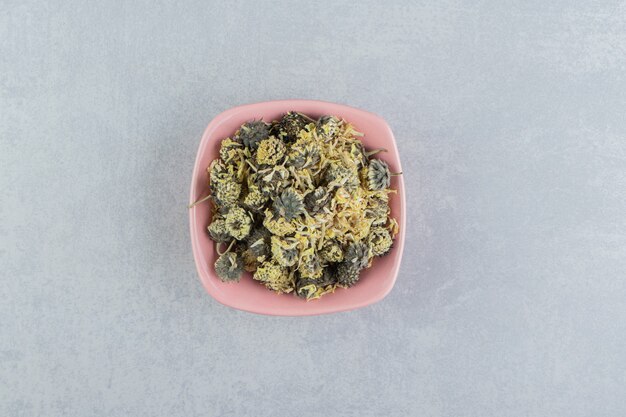 Organic dried flower petals in pink bowl.  