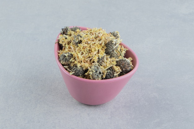 Organic dried flowers in pink bowl.  