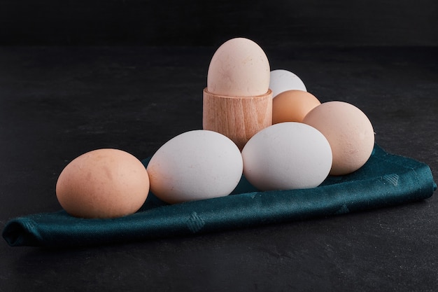 Organic eggs on a green tablecloth . 