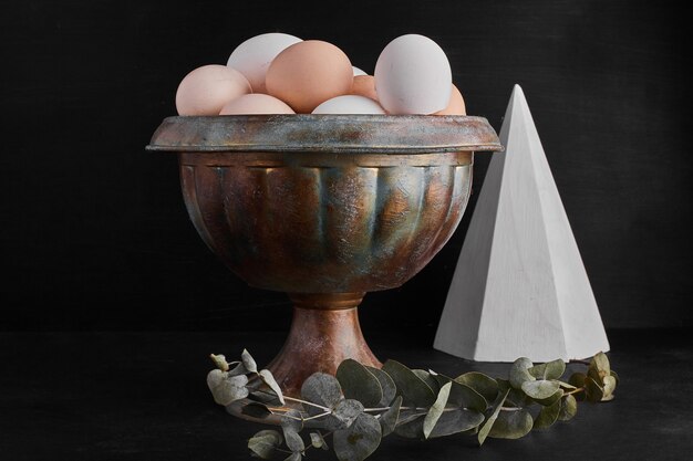 Organic eggs in a metallic cup. 