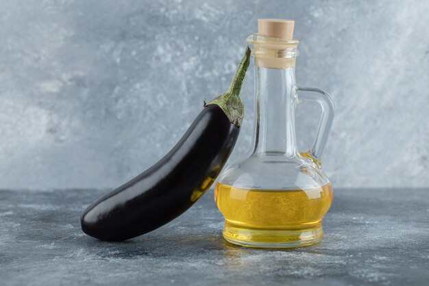 Organic fresh eggplant with bottle of oil.