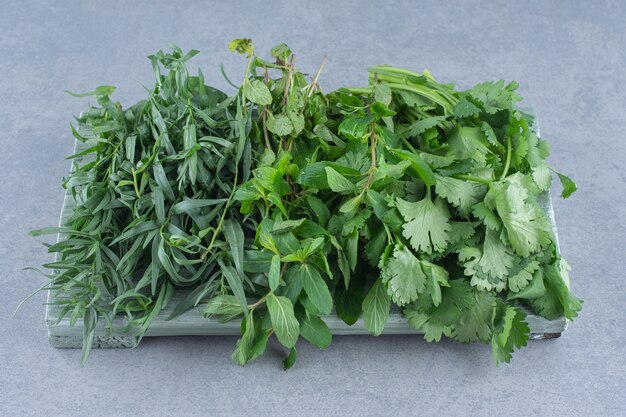 Organic fresh greens on wooden board. 