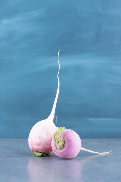 Organic fresh radishes on marble.