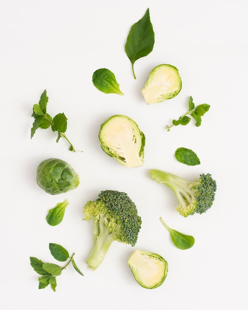 Organic green vegetables on white background