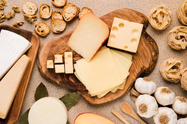 Organic ingredient for tasty breakfast arranged on wooden coaster and plate over background