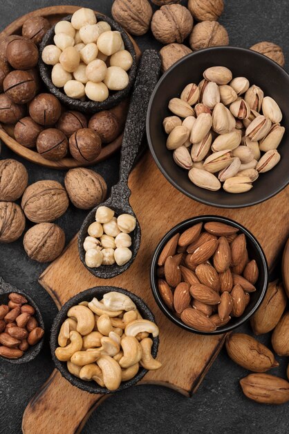 Organic nuts snack in bowls on wooden board