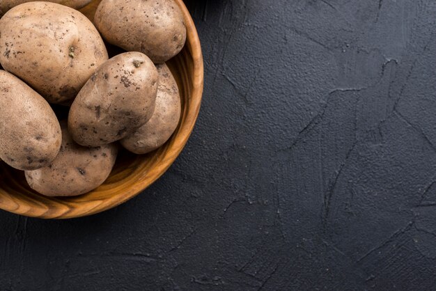 Organic potatoes in bowl with copy-space