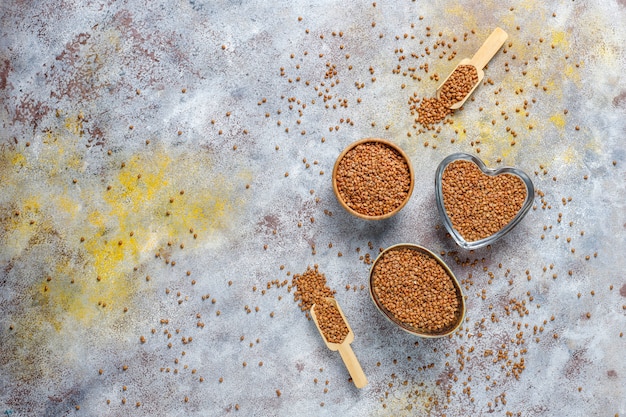 Organic uncooked buckwheat in bowl,top view