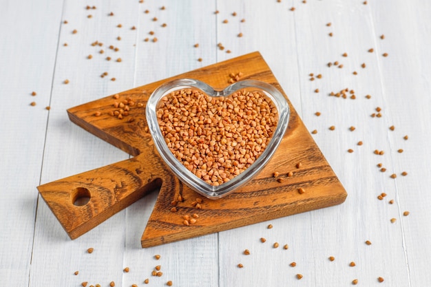 Free photo organic uncooked buckwheat in bowl, top view