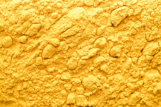 Organic yellow food powder background