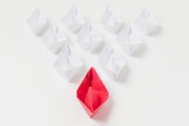 Origami boats leadership concept