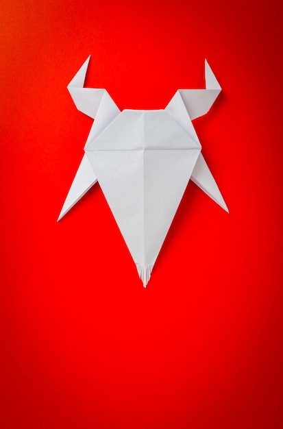 Free photo origami paper goat on red background. new year of the goat 2015.