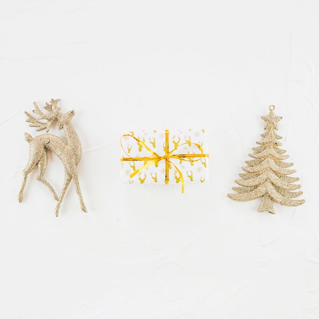 Ornament deer and fir tree near present box 