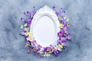 Free photo ornate white frame adorned with purple and white spring flowers