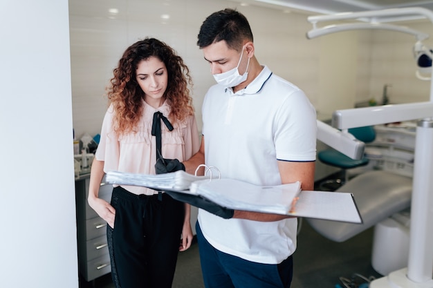 Orthodontist and patient looking at binder