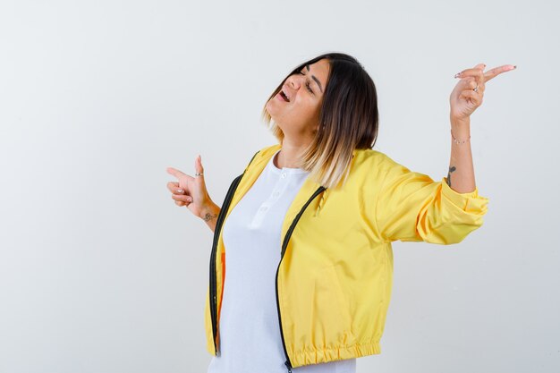 Ortrait of lady pointing left and right in t-shirt, jacket and looking relaxed front view