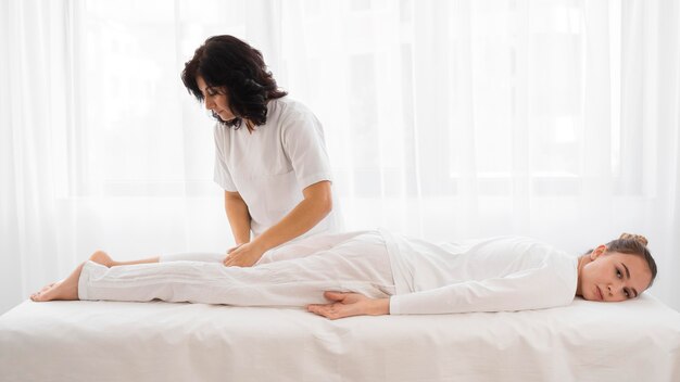 Osteopathist treating a girl at the hospital