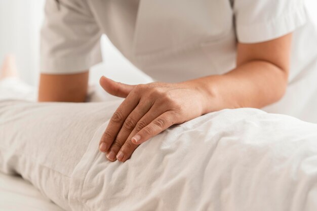 Osteopathist treating a kid by massaging him