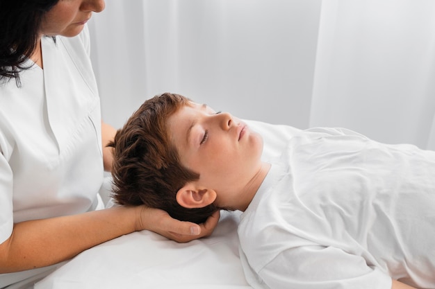 Osteopathist treating a kid at the hospital