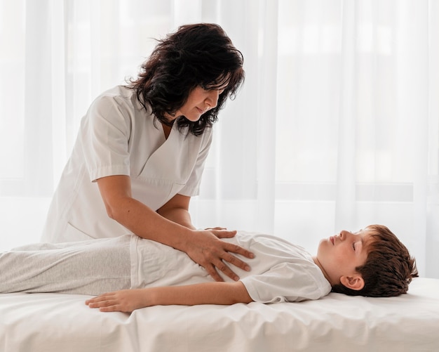 Osteopathist treating a kid's legs at the hospital