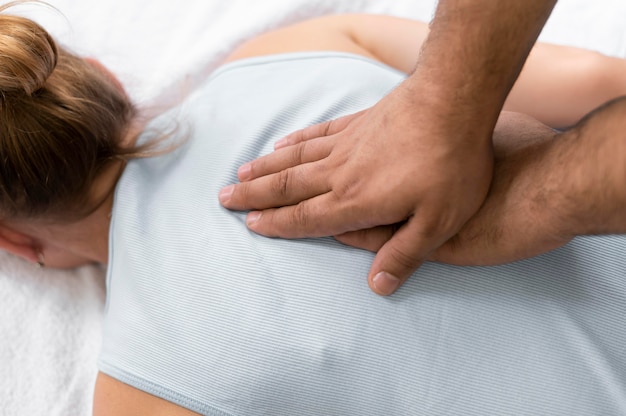 Free photo osteopathy patient getting treatment massage