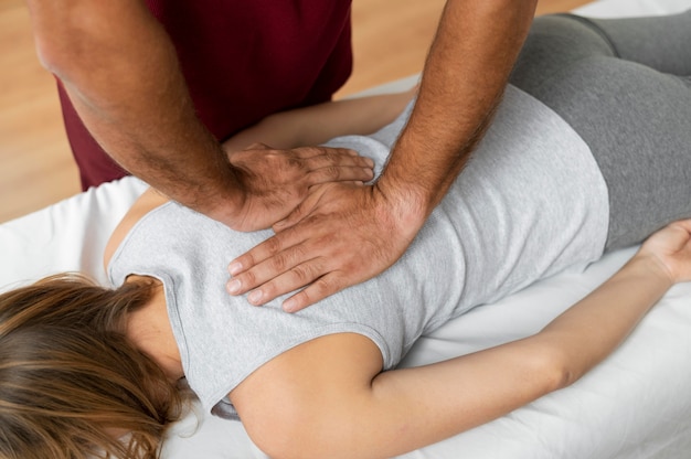 Free Photo osteopathy patoient getting tretment massage
