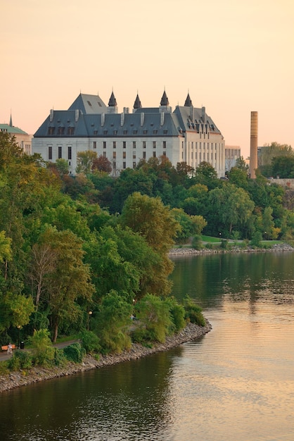 Ottawa sunset over river with historical architecture.