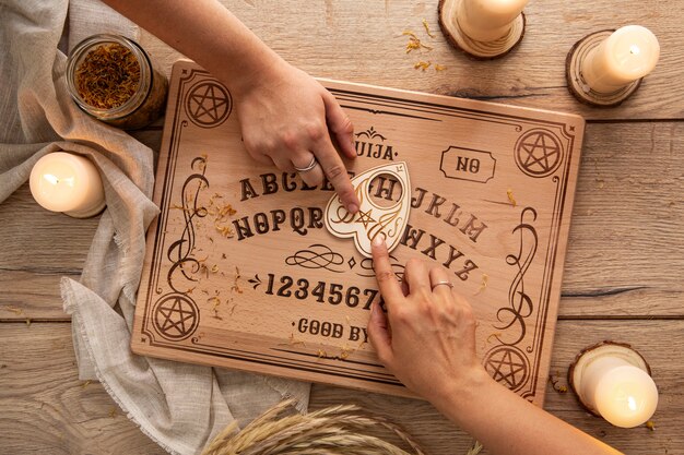 Ouija board and candles arrangement flat lay