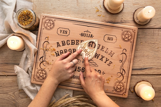 Ouija board and candles arrangement top view