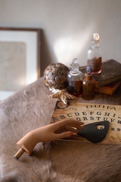 Ouija board and fake hand high angle