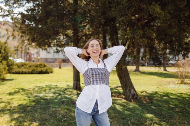 ÃÂoung pretty girl walks around the city smiling and posing