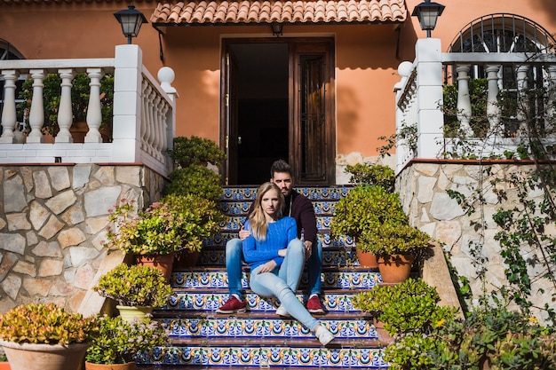 ouple sitting on stairs outside