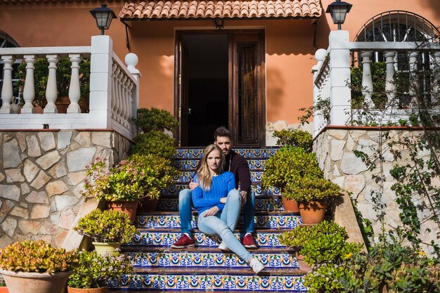 ouple sitting on stairs outside