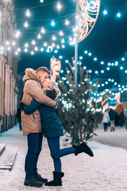 Outdoor close up portrait of young beautiful couple posing on street