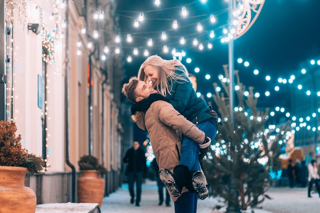 Outdoor close up portrait of young beautiful couple posing on street