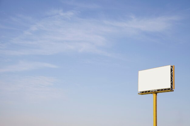 An outdoor empty advertising billboard against blue sky