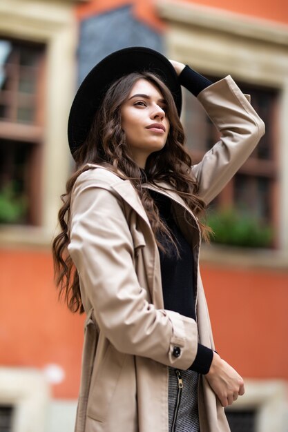 Outdoor fashion portrait of glamour sensual young stylish lady wearing trendy fall outfit and black hat on the street