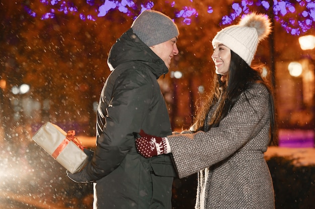 Outdoor night portrait of young couple at the street