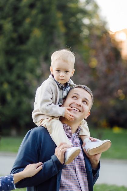 Outdoor portrait of a happy family enjoying the fall season